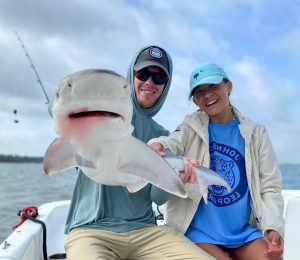 a person holding a fish